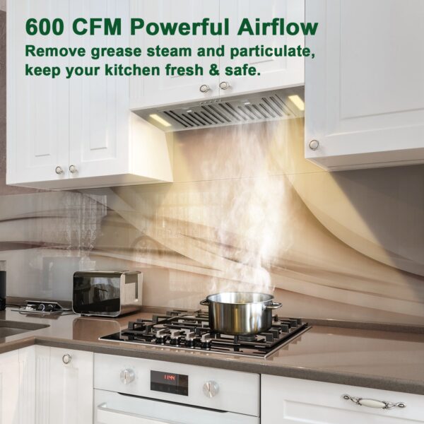 Stainless - steel range hood in action, extracting steam with 600 CFM airflow