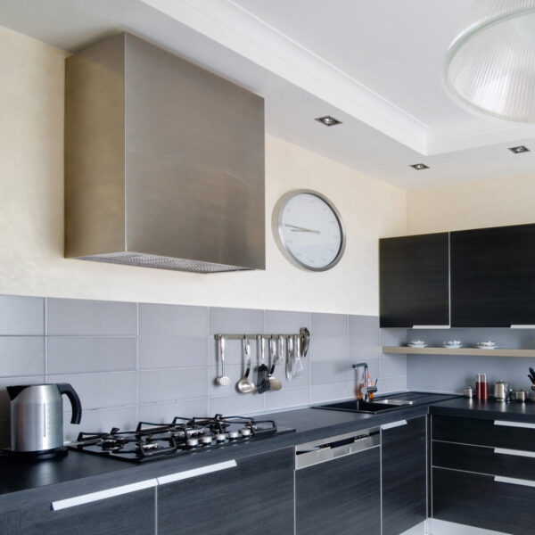 Stainless - steel range hood in a contemporary kitchen