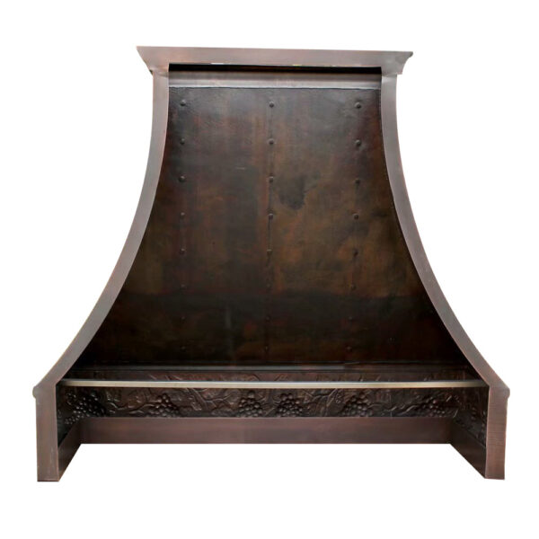 A rustic - styled handcrafted copper range hood with a dark, weathered finish.