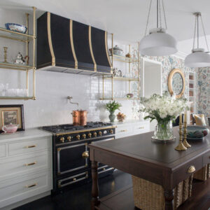 A modern black range hood in a well - designed kitchen