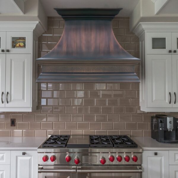 Stainless - Steel Range Hood with a Reflective Finish in a Kitchen
