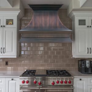 Copper - toned range hood in a bright kitchen