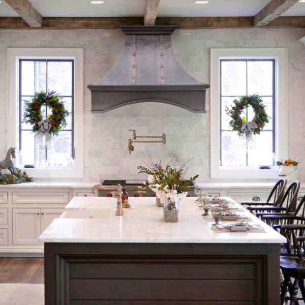 Elegant Range Hood in a Cozy, Wreath - Adorned Kitchen